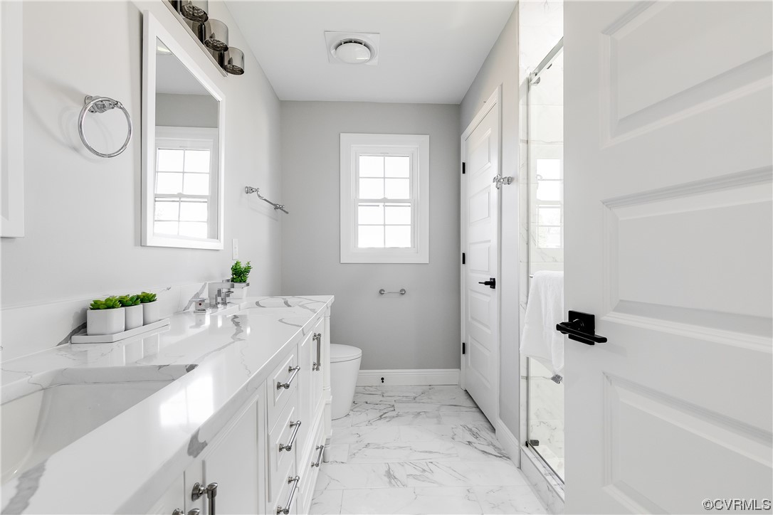 Primary full bathroom with double vanity, a sparkling quartz vanity top, and a shower have you saying 