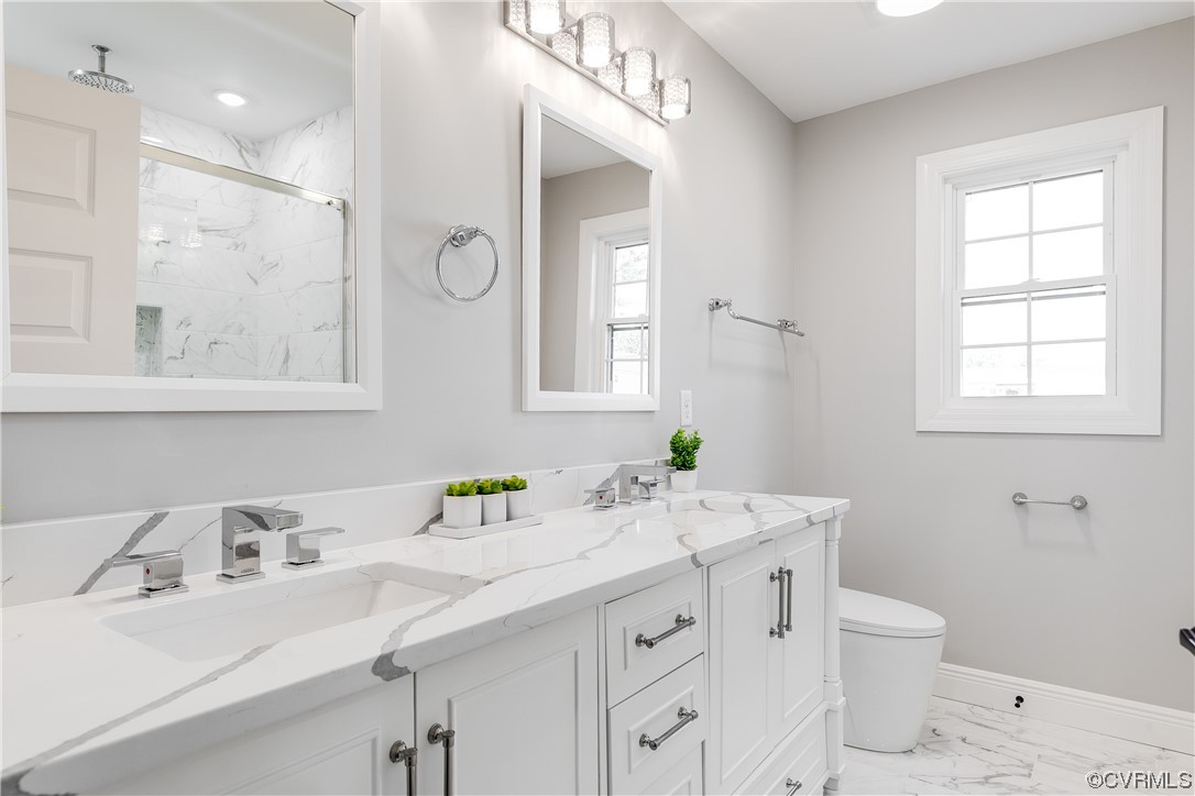 Close up of primary bathroom vanity featuring  high-end quartz vanity top