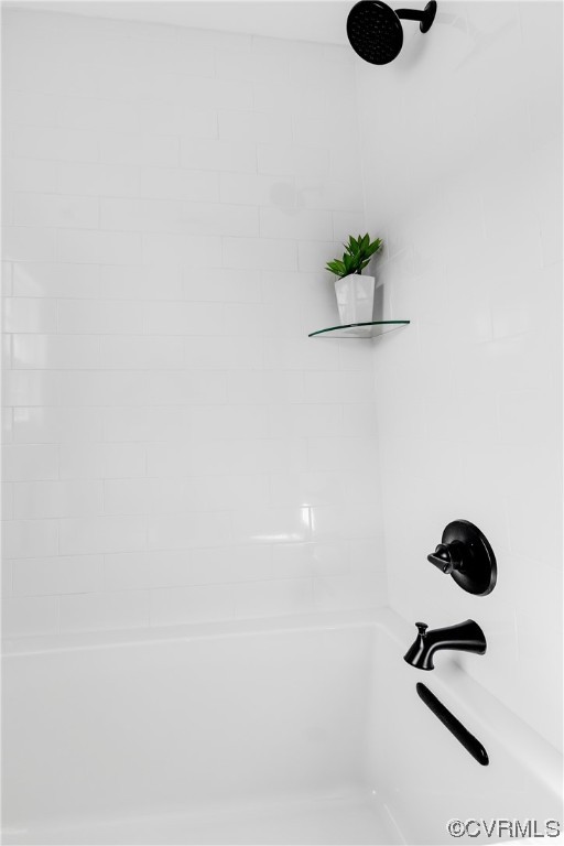 Sleek hall bath fixtures with a glass shelf