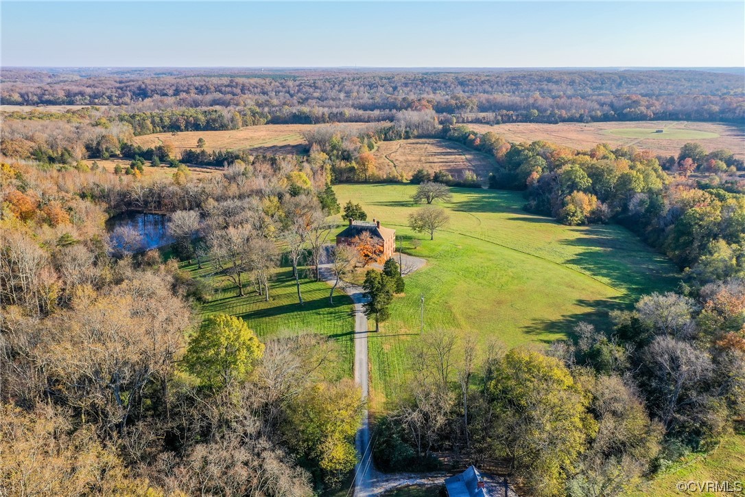 Brick mansion offers spectacular views from the knoll of 672 acres and pond views from the left side porches