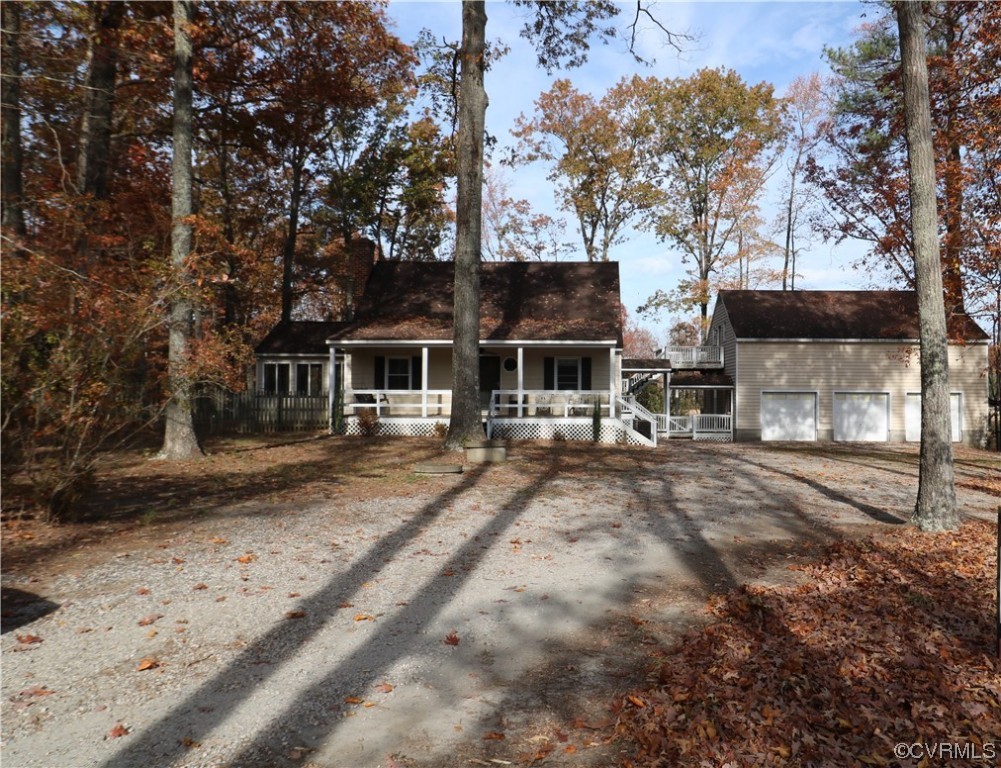 View of front of property with a garage and a porch