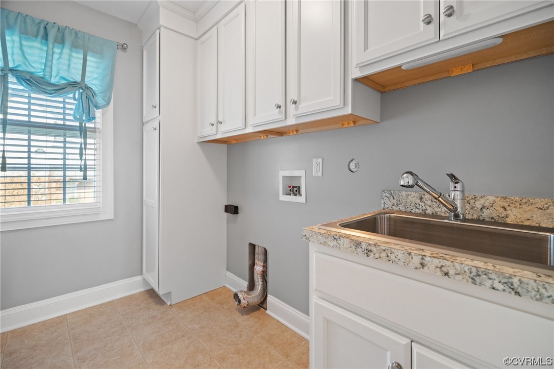 Laundry room with sink and upper cabinets
