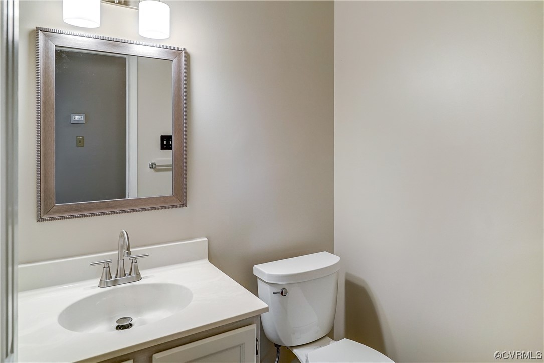 1/2 Bathroom with vanity and toilet
