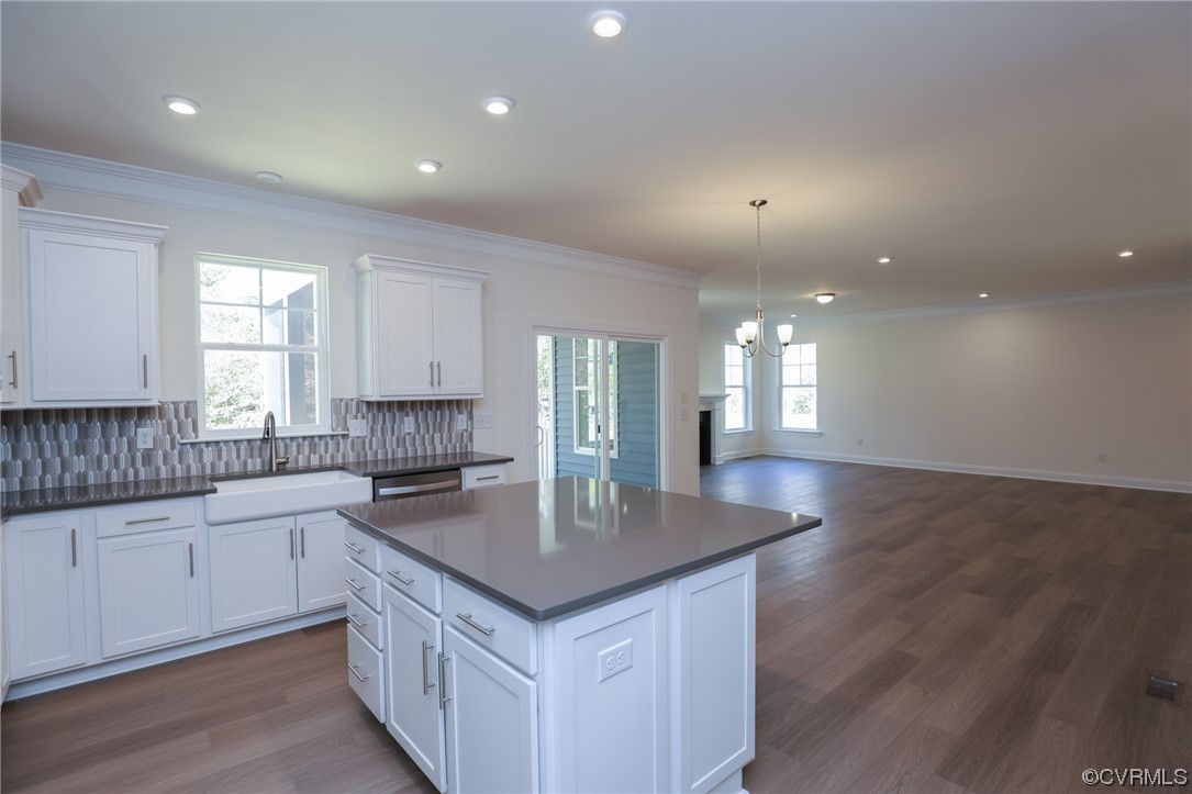 Photo represents the plan, not the actual home. Design selections may vary. Kitchen w/ granite counters, island, walk-in pantry, LED recessed lighting and stainless steel appliances.