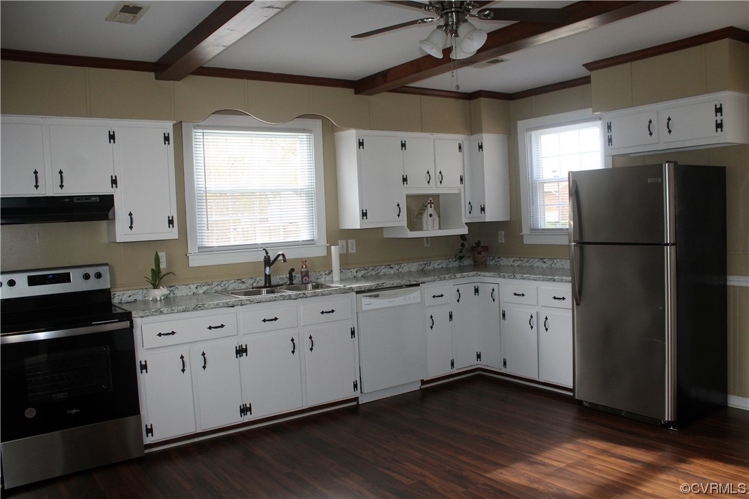 Kitchen with beamed ceiling, undercabinet lighting with remote, sink w new Kohler faucet, white cabinets, dishwasher, new stove, refrigerator