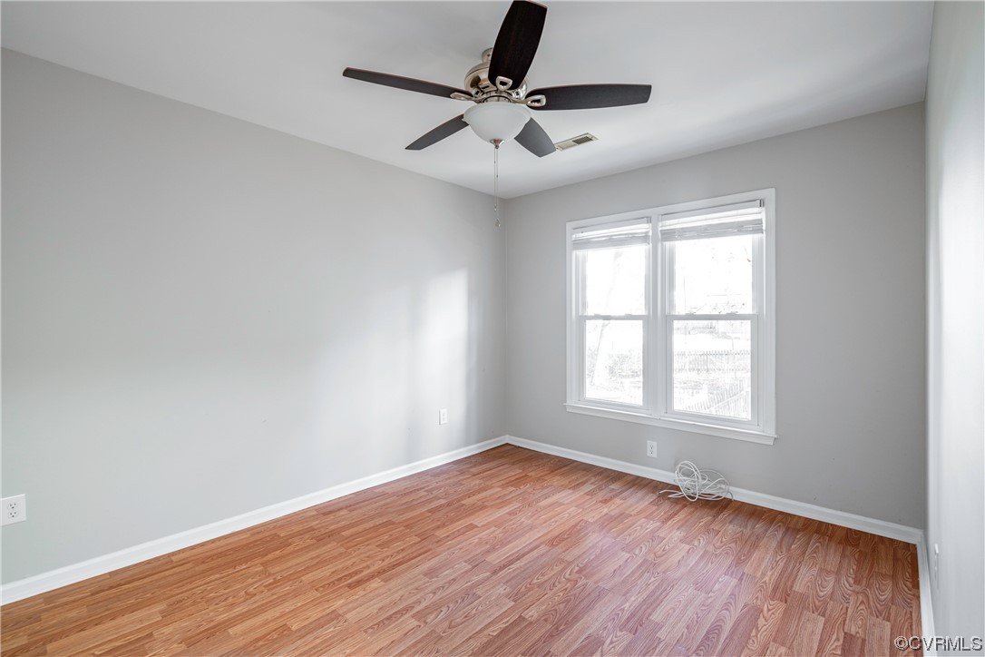 Spare room with light hardwood / wood-style flooring and ceiling fan