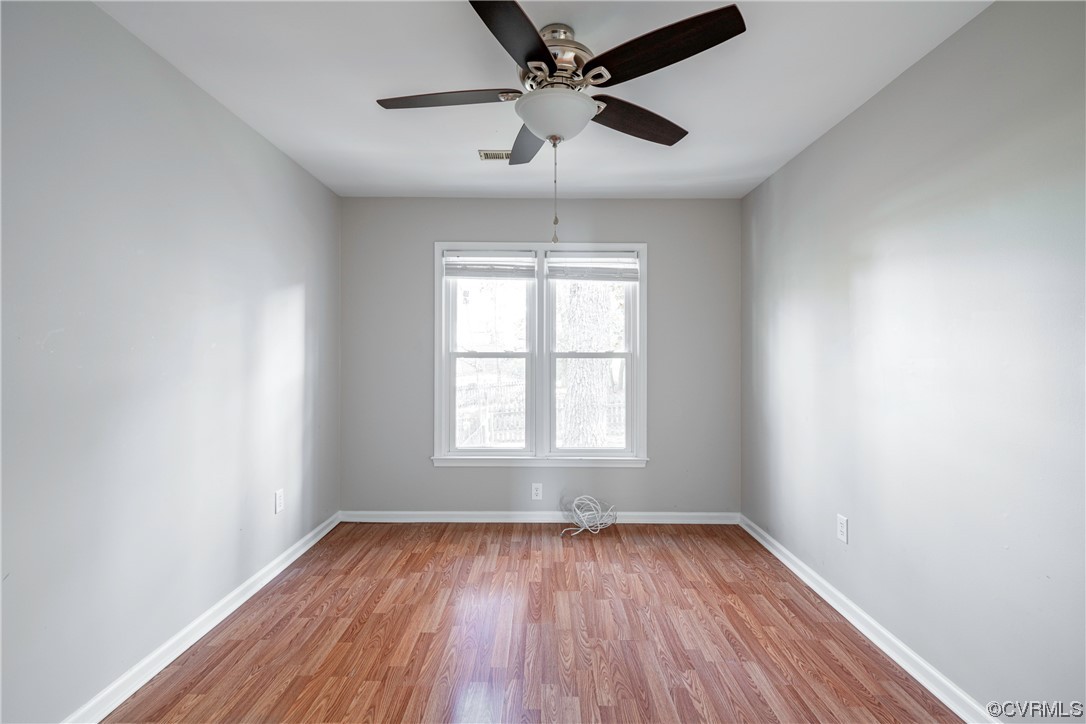 Unfurnished room with light wood-type flooring and ceiling fan