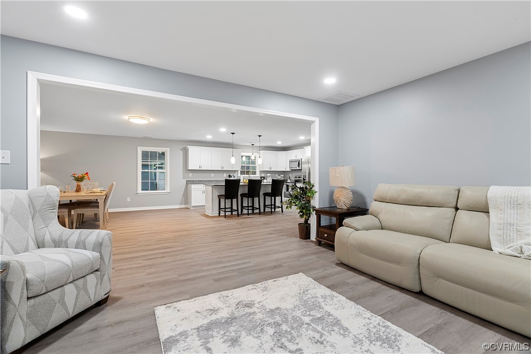 Living room with light hardwood / wood-style flooring