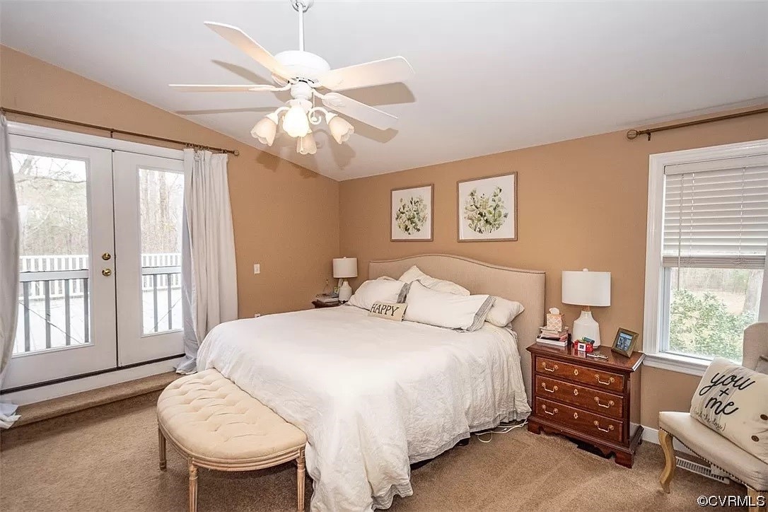 Carpeted bedroom featuring ceiling fan, lofted ceiling, access to outside, and french doors
