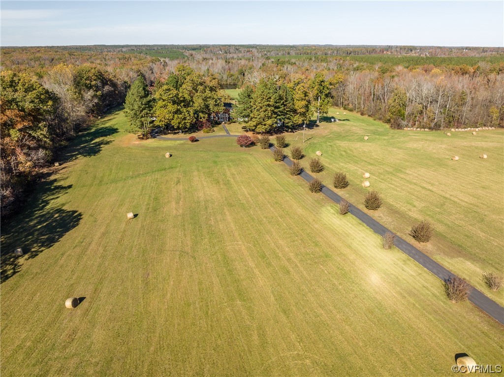 Fall hay bales dot the front fields of this 141-acre rural oasis
