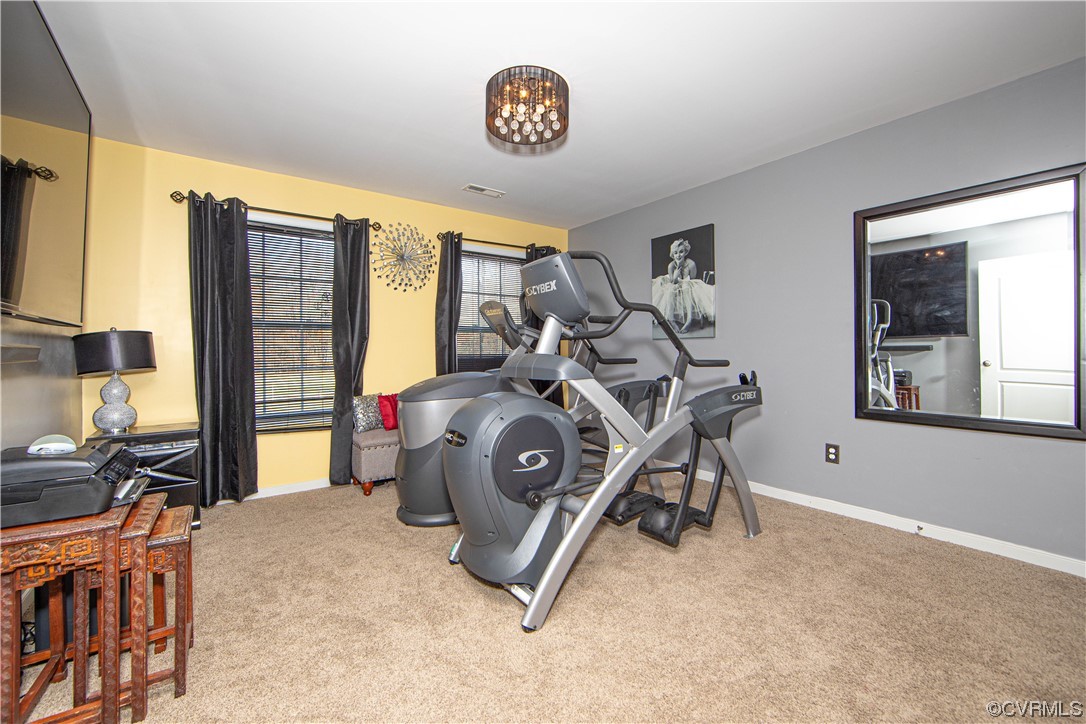 Exercise room with light colored carpet