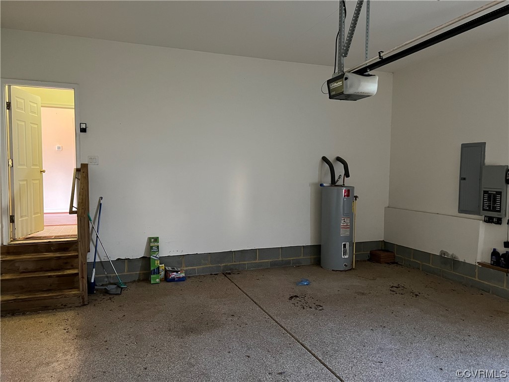Garage featuring water heater and a garage door opener