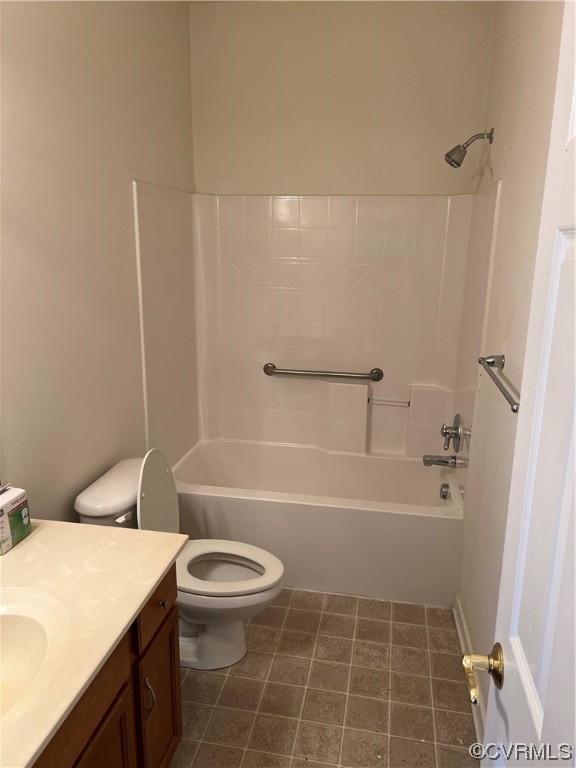 Full bathroom featuring toilet, tile floors, shower / washtub combination, and vanity
