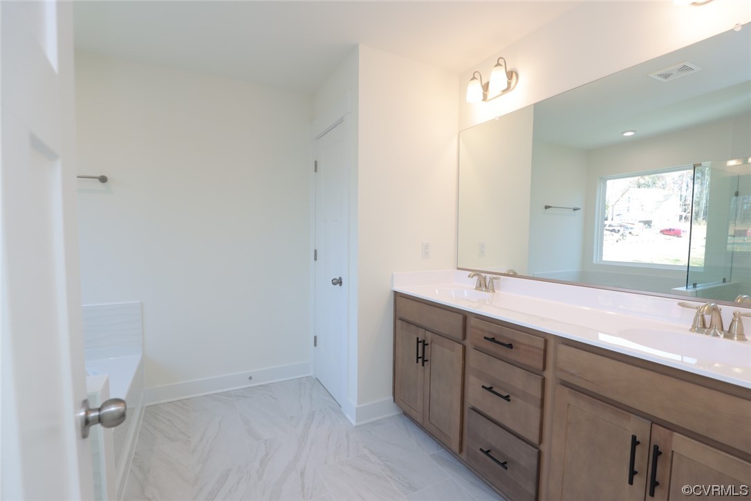 Upstairs, you'll find the primary suite w/ a large walk-in closet and a luxurious 5-piece primary bath featuring a double vanity, frameless walk-in shower, soaking tub and water closet.