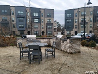 View of patio with a grill and area for grilling