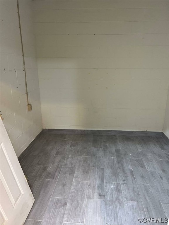 Spare room with dark wood-type flooring