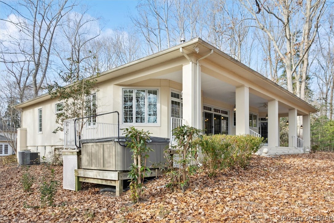 View of property exterior featuring central AC and covered porch