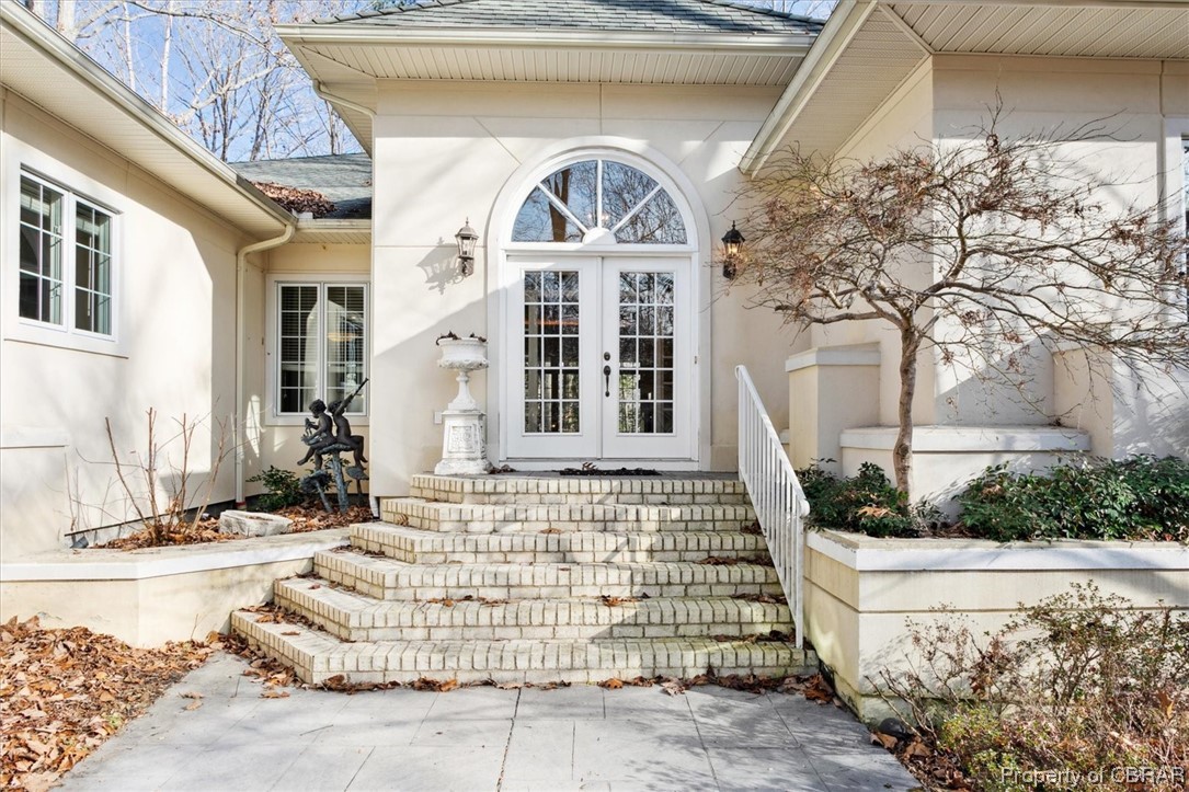 Property entrance featuring french doors