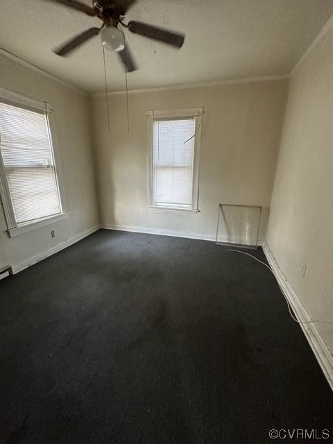 Empty room featuring ceiling fan and crown molding