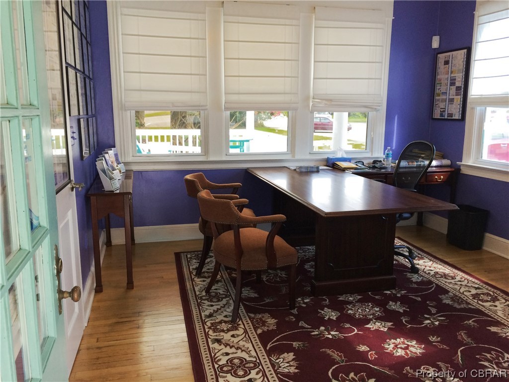 Office with a healthy amount of sunlight and hardwood / wood-style floors