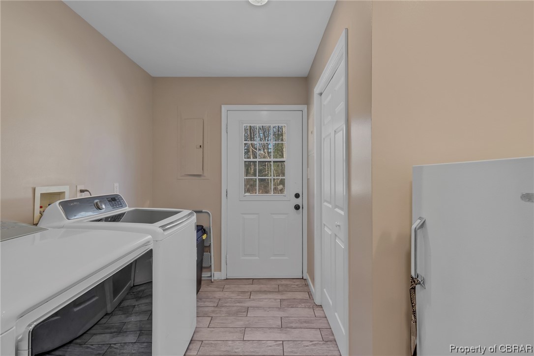Laundry room featuring washer/dryer and half bath. Room for an extra refrigerator