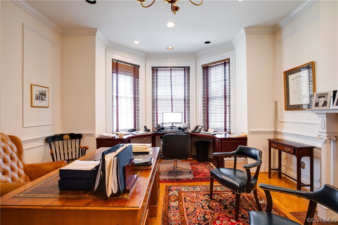 Office space featuring ornamental molding, a chandelier, and hardwood / wood-style floors