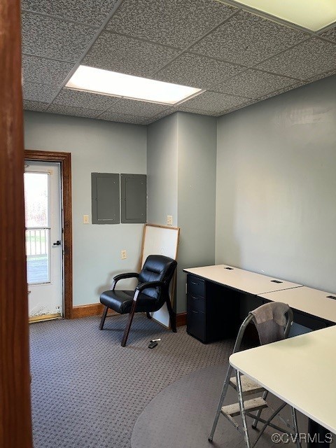 Office with a drop ceiling and dark carpet