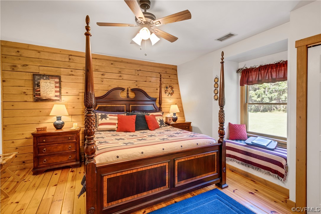 Bedroom featuring light hardwood / wood-style floors and ceiling fan