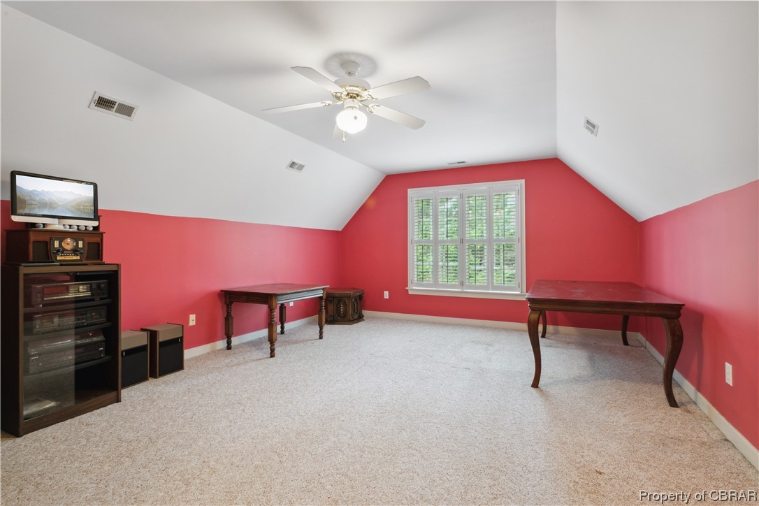 Game room featuring lofted ceiling, ceiling fan, and light colored carpet