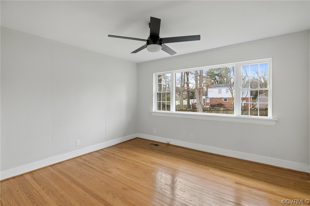 Unfurnished room featuring plenty of natural light, light hardwood / wood-style flooring, and ceiling fan