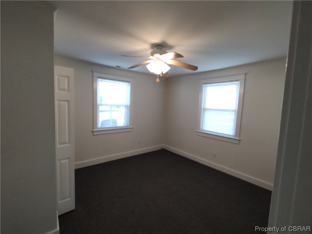 Spare room with ceiling fan