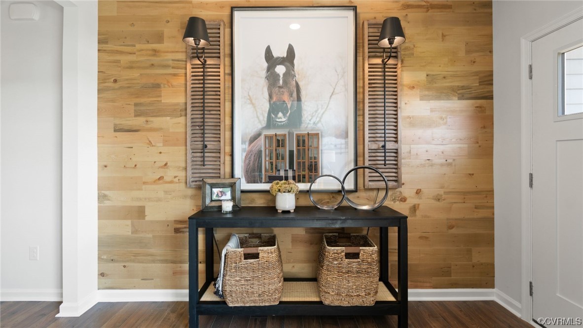 Details featuring dark hardwood / wood-style flooring and wooden walls