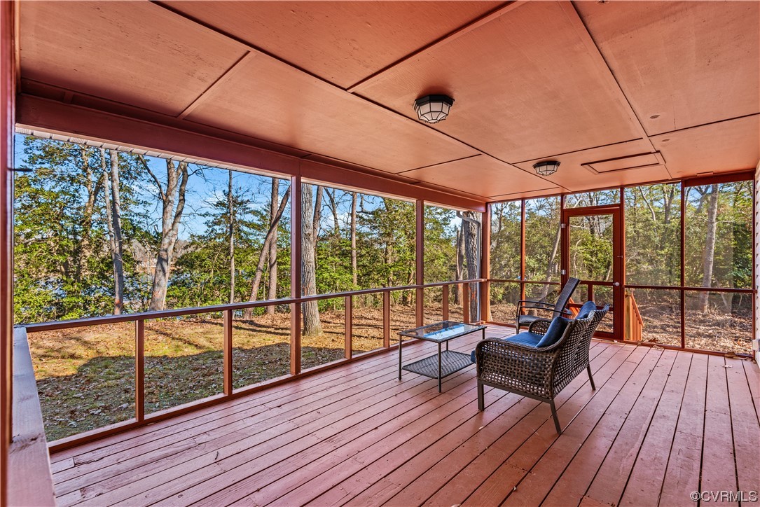 Unfurnished sunroom with wood ceiling