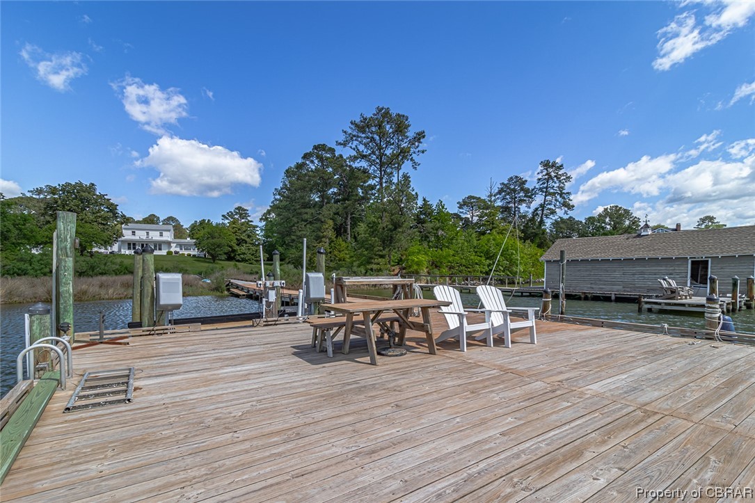 Deck featuring a dock and a water view