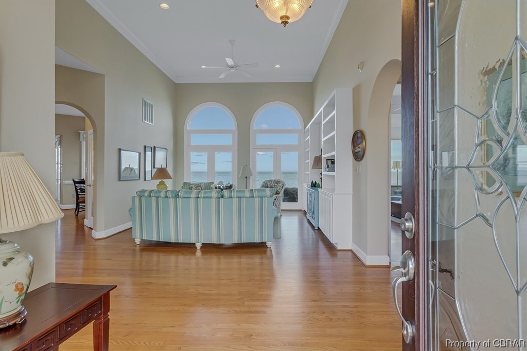 Foyer entrance with light hardwood / wood-style flooring and ceiling fan