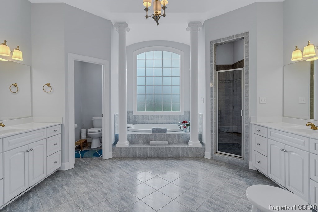 Full bathroom featuring vanity, a chandelier, and tile flooring