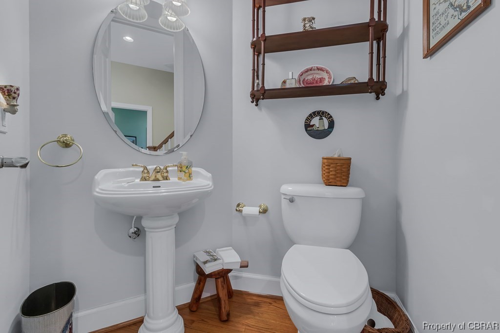 Bathroom with hardwood / wood-style flooring and toilet