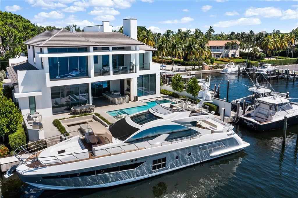 A coastal turn key modern masterpiece in Harbor Beach. Here awaits a private beach club, security + marina. Direct Lake Sylvia/Intracoastal access. Las Olas Blvd. shopping within 5mins. A total oasis outback - 100ft of waterfront dockage space is yours + a custom pool, fire pit, and chef’s cooking space. Superior design and construction by Randy Stofft/Sarkela Corp. Open and entertaining-ready layout! Main level: Gourmet kitchen w/ Wolf + Sub-Zero appliances; wine wall; 2-sided fireplace; glass-enclosed library opens to club room; elevator + main level suite w/ balcony. A Wall of windows along its back opens to the pool area. 4 bedrooms upstairs - each w/ luxury baths and balconies. Laundry room on both levels, a private rooftop terrace + smart tech (Sonos, Lutron + Energy Star).