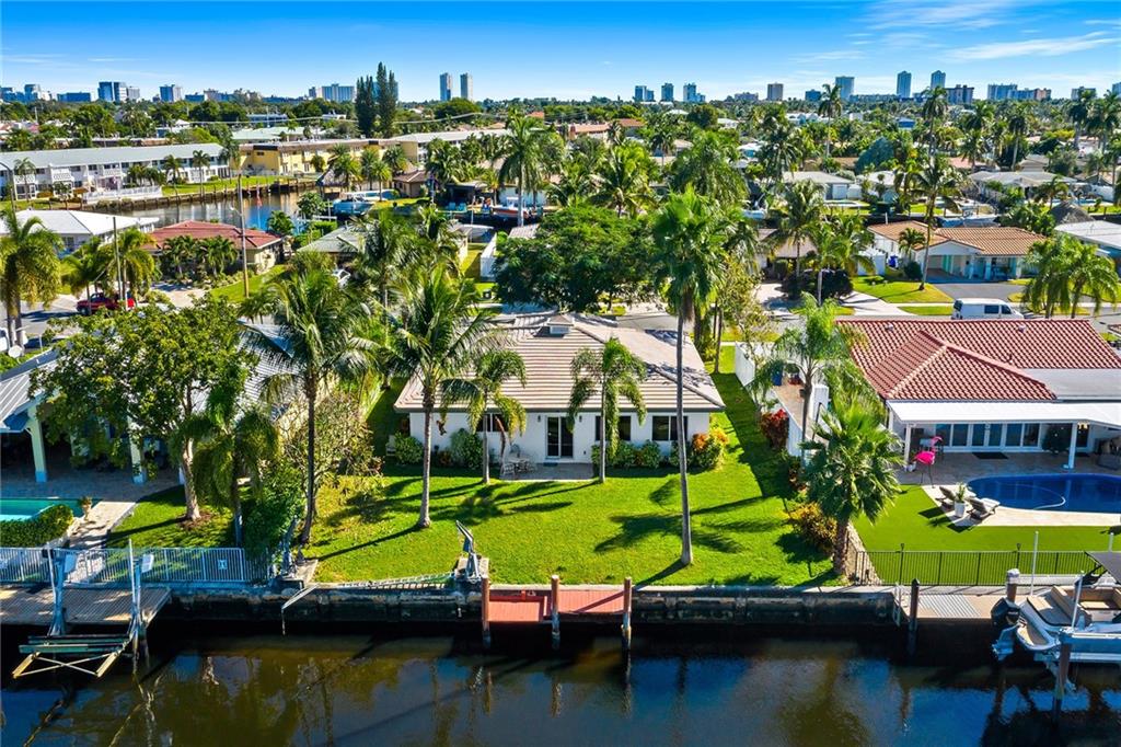 Deep water/ocean access !! Updated waterfront home on super wide canal with a spectacular view of intersecting canals in highly desirable Garden Isles neighborhood. 75 ft on the water -minutes to the intracoastal. Spacious and open floor plan. Updates include kitchen, tile flooring throughout, new appliances and impact windows. Volume ceilings in the family room. Flat tile roof replaced approximately 2012. Circular driveway and 2 car garage. Plenty of room for a pool and/or your own tropical oasis. Great lot location on a cul de sac street in subdivision with sidewalks on both sides of the street. Close proximity to the beach, restaurants and shopping. Long time owner moving north ! Easy to show!