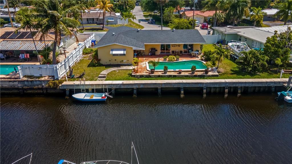 Enjoy the South Florida lifestyle at this waterfront, ocean access, pool home in the quiet neighborhood of Boulevard Park Isles. This is a fantastic opportunity to create your dream waterfront home. The house features a split bedroom floor plan and offers the perfect balance of indoor-outdoor living with glass slider doors and windows facing the pool deck from almost every room.  Most of the big items have been recently updated: completely new seawall with batter piles, new roof in 2018, new AC and water heater.  You do not want to miss this opportunity to own a piece of paradise. Bring your boat and your vision to this ocean access home and make it your own. This property needs some work.