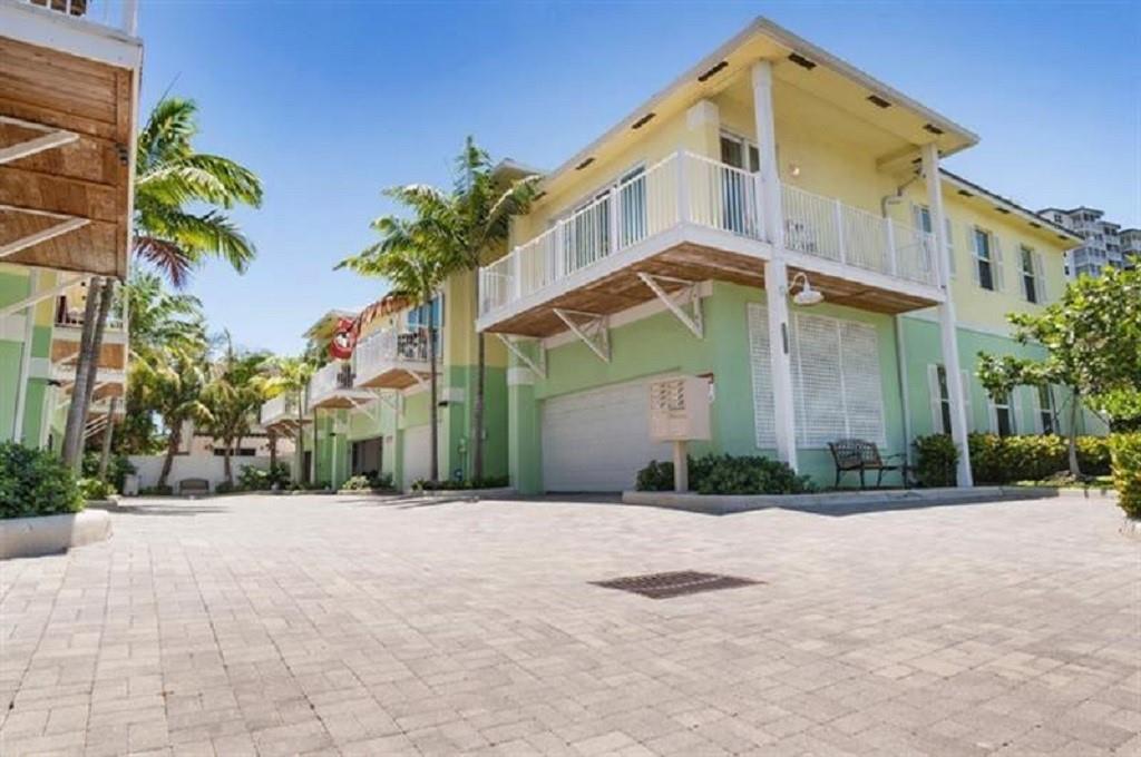 This TOWNHOUSE built in 2014 brings the charm of Key West directly to Pompano Beach ***2,525 sf TOTAL AREA ( including garage)*** Nested between the intercoastal and the beach to offer the best of the 2 worlds . Take the water taxi to your favorite waterfront restaurants and/or walk to the beach . Gallery entry hallway with 3 bedrooms and 3 full bathrooms. Huge master bedroom downstairs and a second small master bedroom up-stairs . Vaulted ceilings, wraparound balcony, sliding glass doors that slide completely back to catch the cool ocean breeze, impact windows, metal roof, 2 car garage and a back patio to enjoy your BBQ. Pet friendly . Low $460/month HOA to cover building exterior, common areas, landscaping, sewer , trash removal, etc. OK TO LEASE minimum 120 days for up to 3 times a year