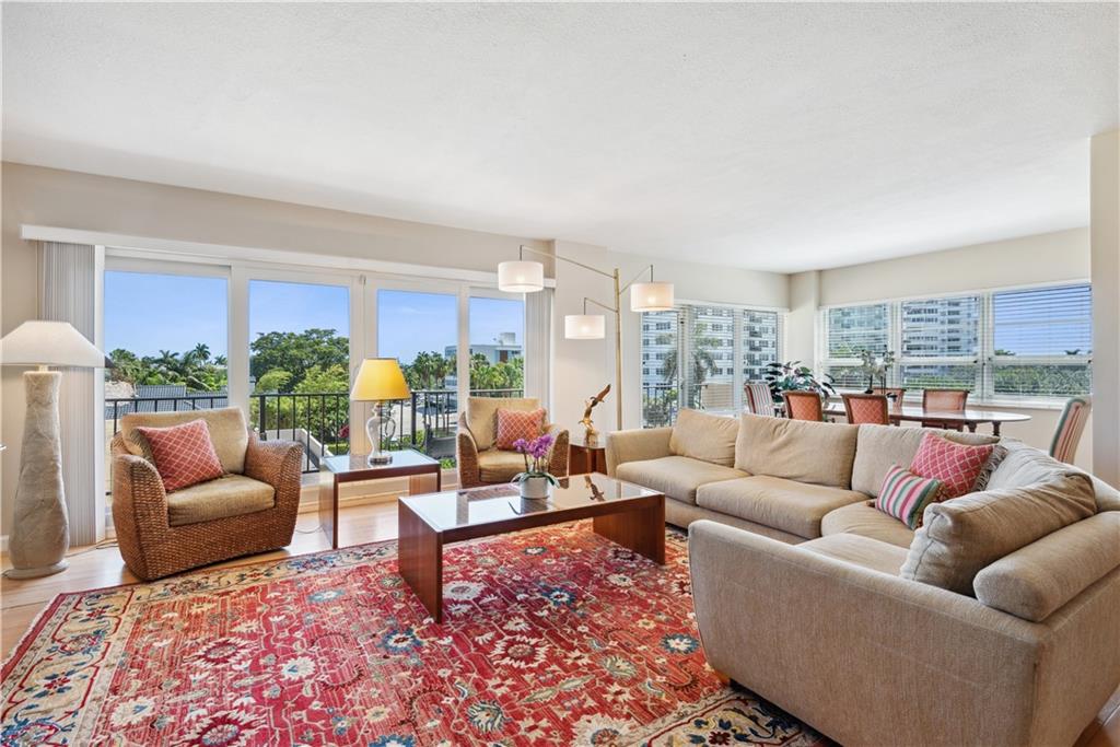 Welcome to this beautiful, corner unit located at the intersection of the intracoastal & Las Olas Blvd. This open floor plan features an updated open kitchen, breakfast nook & large living/dining area all surrounded by southern views & impact windows flooding in natural light from sunrise to sunset. Across from the powder room, french doors open to a perfect home office space, den or nursery.  Large primary bedroom boasts walk-in closet & walk-in shower.  This corner unit has a third bedroom and second full bathroom with easy access laundry to make guests feel welcomed. In addition there are 2 storage cages & assigned covered parking.  Building offers an outdoor pool/bbq area, exercise room, library, hobby room, clubroom and a location that can't be beat less than 1/2 mile to the beach.