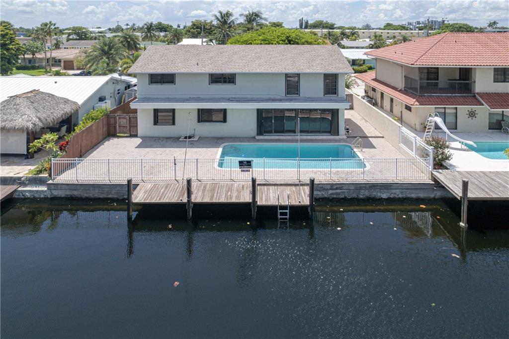 LOCATION! LOCATION! LOCATION! Fabulous 2 story home on the canal in Pompano Beach with easy ocean access. This home has 3 bedrooms, 2.5 bathrooms, a private office and a wall of sliding doors that open up to a beautiful backyard, pool, paver patio, outdoor shower and a private dock to park your boat. Florida living at its best! This property is ready for your personal touches and updates.... Highly desirable Snug Harbor neighborhood with only 1 bridge to the inlet. (Federal Hwy bridge, 12ft clearance at high tide). No HOA! Amazing schools close by...Pine Crest, Westminster Academy, Cardinal Gibbons, Pompano High.