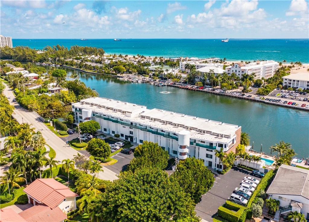 Be the first to enjoy this completely renovated, 2-story townhouse overlooking Lake Mayan and partial ocean view! One block to the beach! Enjoy coffee and sunrise from your 4th or 3rd floor private balcony. BOATERS: Unit includes a dock slip, (2 fixed bridges. Extra fee for dock use.)  Living area has soaring ceilings with cheerful daylight streaming in from skylights. Living, dining, kitchen, half bath and balcony upstairs, and two bedrooms and two full baths on lower level. Open kitchen includes wine refrigerator.  Both bedrooms have huge walk-in closets. Gorgeous, newly renovated pool area overlooks lake and docks. The property has been newly landscaped and the building just had a total contemporary redesign of front face. Available immediately! First, Last, Security, Background Check.