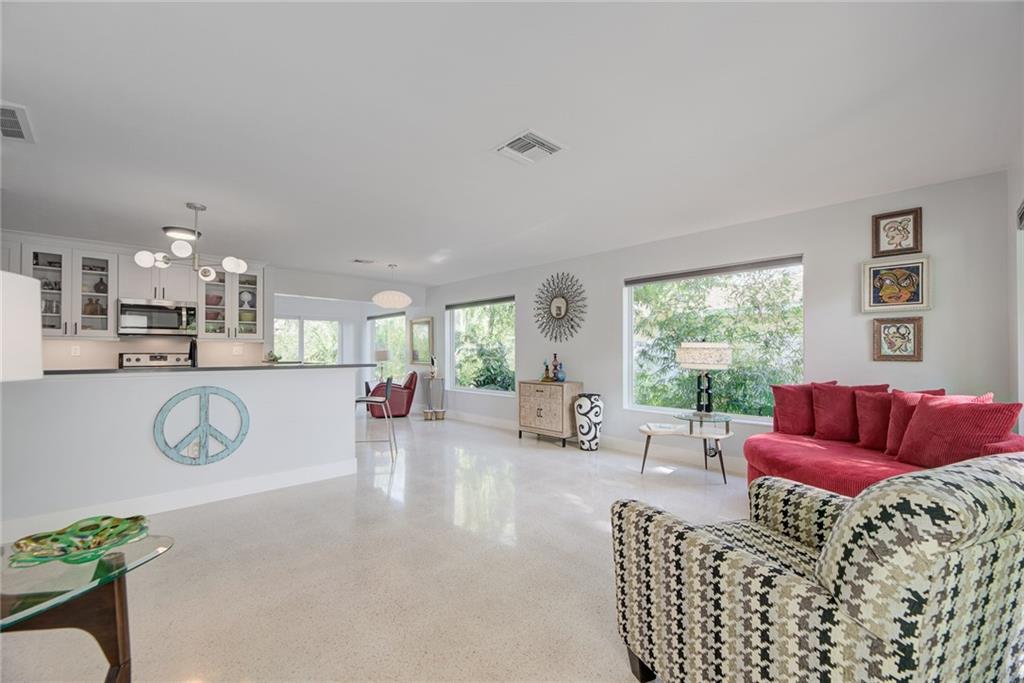 Wilton Manors Mid-Century Modern Gem! Restored and renovated with attention to every detail! 3 bedroom/2 bath w/restored original Terrazzo floors. Updates include Electrical (2019), Impact Windows and Doors (2020), Kitchen (2018), Bathrooms (2022), Roof (2018), Water Heater (2018), Sprinkler System (2021), Main Water Line (2015), Custom Wood Fence (2021) and Custom Gutters (2020), ERV vent system (2020) and updated A/C. Home Electrical supply has an outside generator direct connection. Large storage area in the carport. Back bedroom includes ensuite bath and a separate outdoor entrance for airbnb potential. Tranquil patio area in a beautifully landscaped backyard. Do not miss!