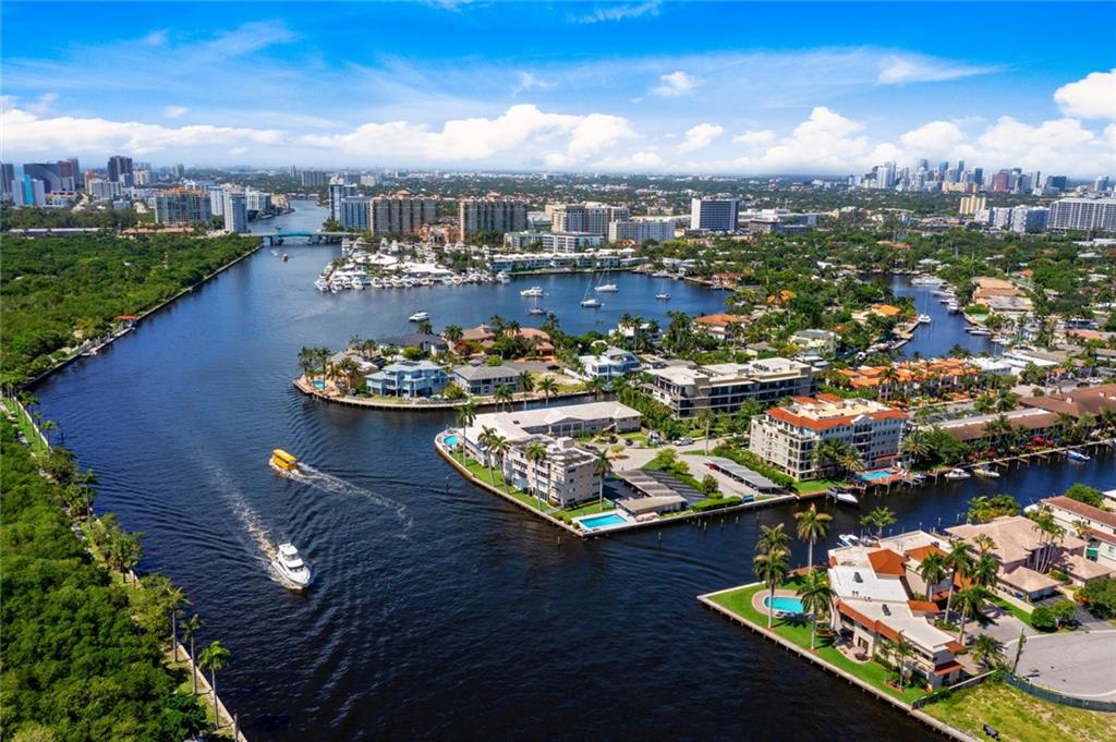 Unique Opportunity! Rarely Available! Direct Intracoastal 3/3 Townhome with Dockage. Enjoy the constant parade of boats & exceptional views of Birch State Park. Desirable end unit features luxuriously customized kitchen w/Miele gas stove, Verde Borgogna leathered Countertops, Walnut Cabinets, Sub Zero refrigerator, Fisher Paykel Double Drawer Dishwasher, separate pantry. 3rd BR downstairs (currently used as office) and laundry room. Separate Loft upstairs, perfect for gym or office. Balcony off primary with his/her closet, ensuite bath & marble floors. 2 new ACs. Custom finished 2-car garage with specialized auto flooring, cedar planked ceiling, utility sink & built-in storage. Impact doors & windows throughout.  Enjoy Al Fresco dining on your private patio. Extra storage room outside.
