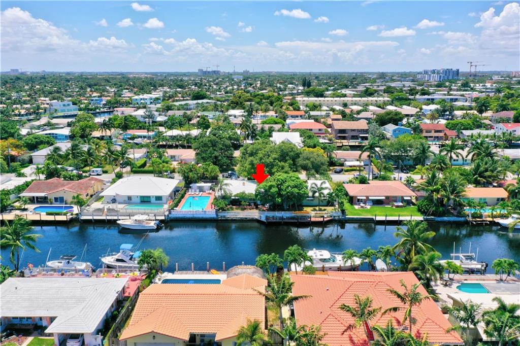 WOW, this is your rare opportunity to own a true double lot offering 140 feet of waterfrontage on a 95 ft wide canal. Located in booming Pompano Beach, this 4 bedroom 3 car garage home offers a HUGE 9' DEEP pool along with wonderful eastern exposure and water views! This can be renovated into a beautiful sprawling ranch, or knocked down & developed into your dream luxury estate or be divided into two full seperate lots and two seperate homes! Dock multiple boats and water toys and enjoy a short cruise to the ocean, restaurants & other entertainment.  Home needs complete renovation. Bring your plane to Sheltair & horse to Sand & Spurs!  Enjoy everything that Pompano Beach has to offer.