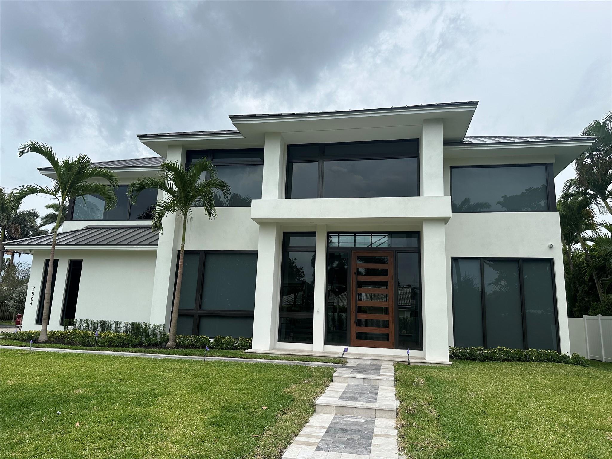 Spectacular new-build by award winning builder/designer Glenn Wright on a beautiful corner lot in Coral Ridge. Masterfully created to raise the bar in contemp architecture w/ floor to ceiling windows for full length views of the lush landscaped tropical & spacious backyard. Sophisticated open floor plan w/ 5 bedrms, 5 baths, plus a powder room. A masterpiece transitional smart home featuring a crackling fireplace for intimate gatherings in the 21' tall great room, Chef’s Italian kitchen offer Sub-Zero & Wolf Appliances. Outdoor kitchen compliments the best of poolside living/dining. Spa-like ambiance w/luxurious bathroom accoutrements in primary suite plus walk-in closets. 3-car side loading garage creates a spectacular front elevation. Coffee bar, cabana bath, expansive lanai, and MORE!