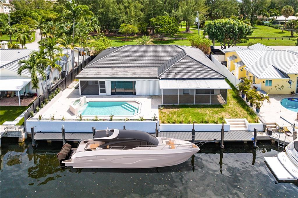 Stunning Boaters Paradise with 80 FT Dock on Deepwater, with No Fixed Bridges to Access Ocean! Start living in your dream home 4 BED/3 BATH with POOL & Newly renovated in the coveted Country Club Isles neighborhood, quite and beautiful area with view of Harbor Park with children's playground, tennis and basketball courts, and walking trail! Stunning timeless bright and modern style remodel includes large porcelain tile, and recessed lighting through the home, bathrooms featuring rain showers and new vanities, 2 NEW A/C units, and primary room has built in closet space for additional storage. Sit and enjoy your morning coffee with in the enclosed patio space from your primary room over looking the pool and canal. Perfect home for entertaining with large open kitchen and stain and heat resistant quartz countertops, new stainless steel appliances, and plenty of seating area at the bar! Great for an investment property with NO-HOA or Rental Restrictions! COME SEE THIS LUXURY HOME OPEN HOUSE THURSDAY 09/22 12AM - 6PM AND SUNDAY 09/25 11AM -4PM
