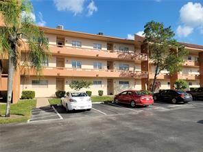 Upgraded 2nd floor unit in the desired Greens of Tamarac.  Tile flooring throughout including the Florida room.  New fixtures and newer A/C.  Clean and move in ready.  Custom mirrors.  Large bedroom.  Can be sold partially furnished.  55+ community.  Enjoy South Florida living at it's best.
